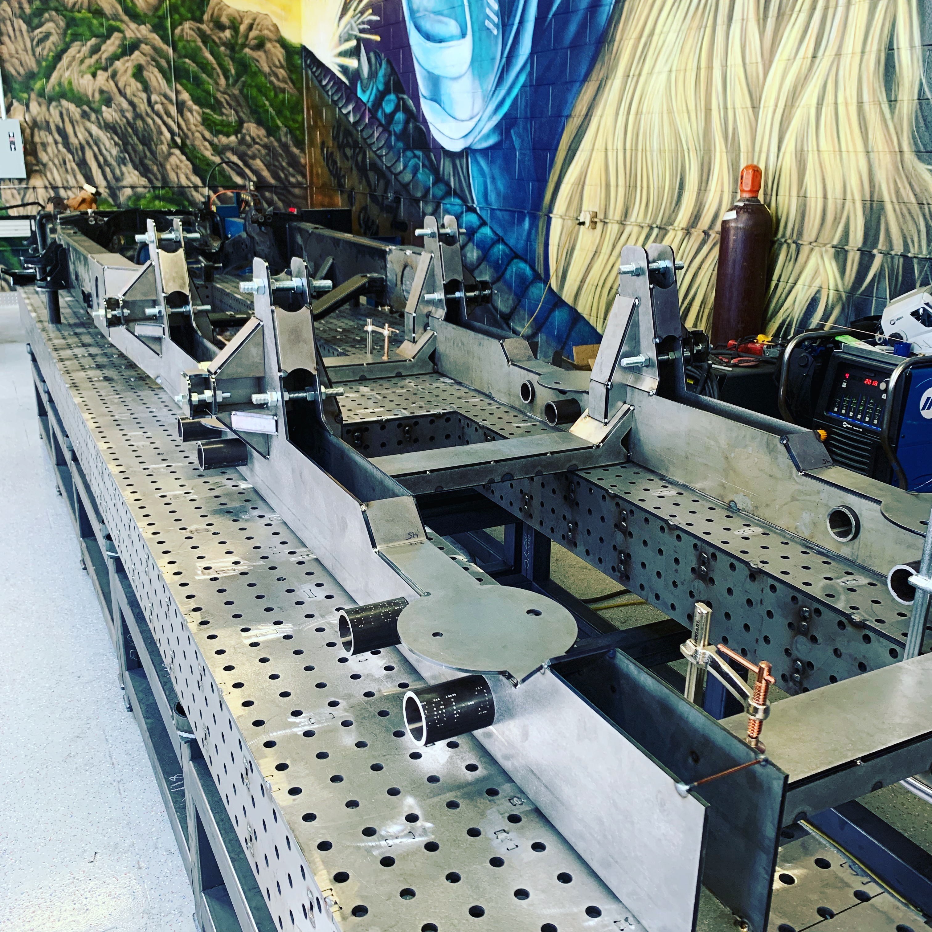 Frame jigs set up on welding table