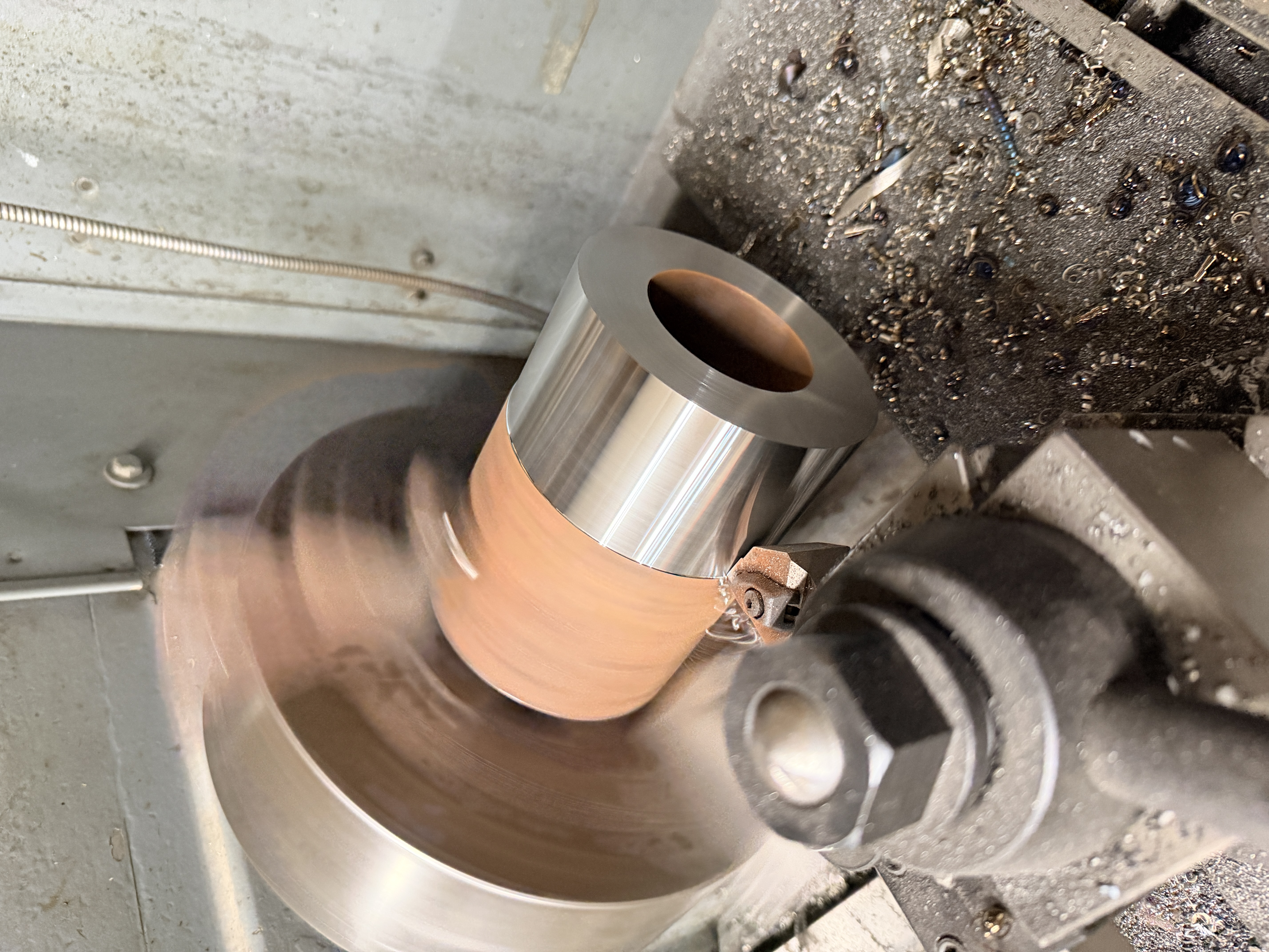 Lathe turning a bronze bushing