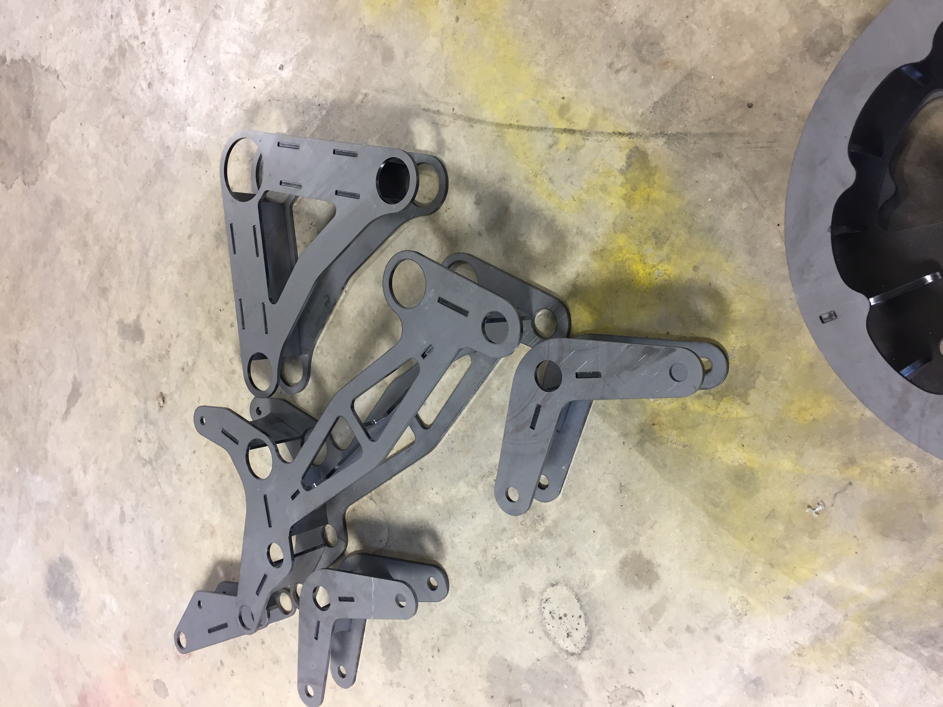 Machined suspension arms and sprocket parts